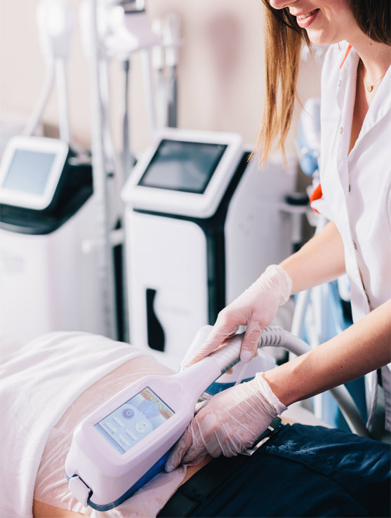 Medical professional using CoolSculpting device on patient's lower back.