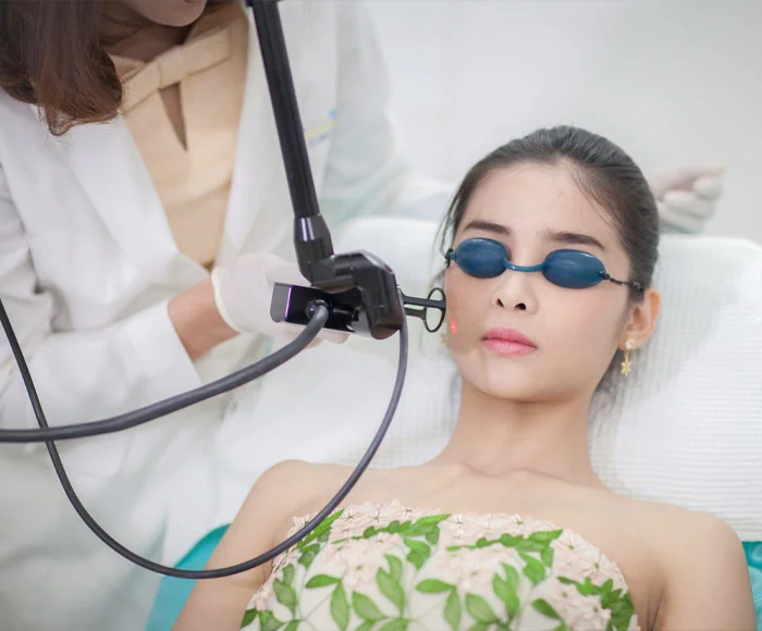 Woman receiving professional laser skin treatment at Dr. Thaj Laser Skin & Hair Clinic